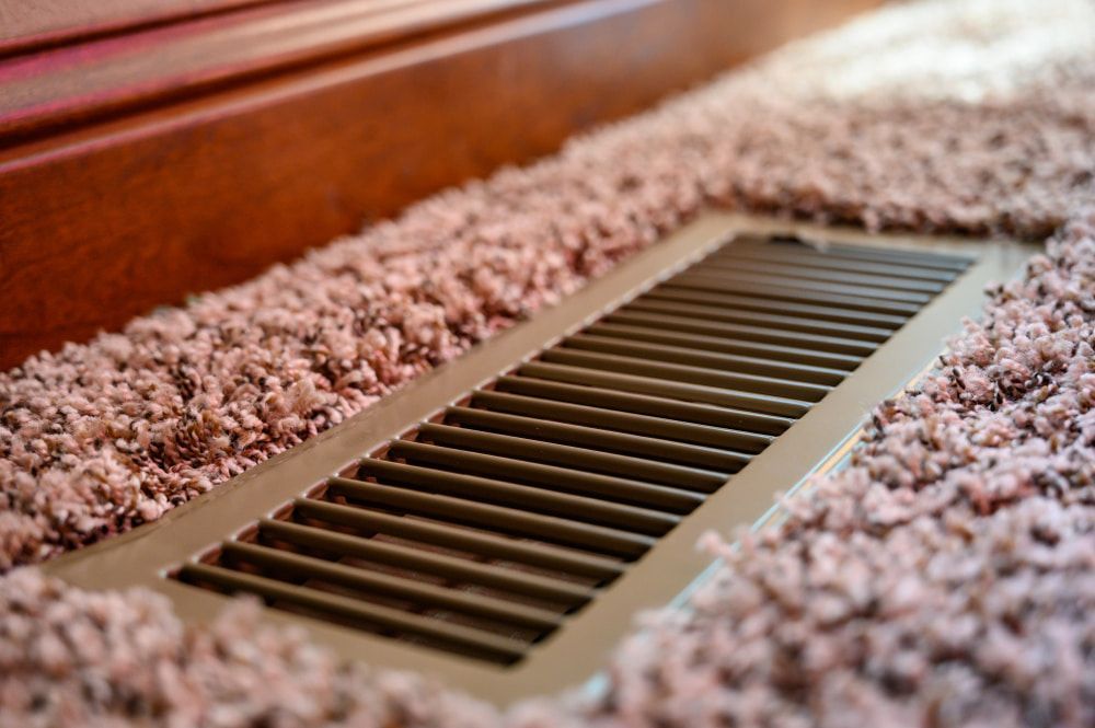 A Close Up Of A Vent On The Floor Next To A Carpet — The Woolmen In Alstonville, NSW