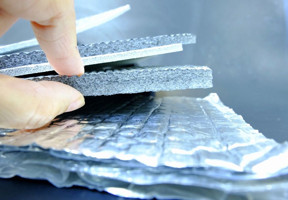 A Person Is Holding A Piece Of Foam On Top Of A Piece Of Aluminum Foil — The Woolmen In Alstonville, NSW