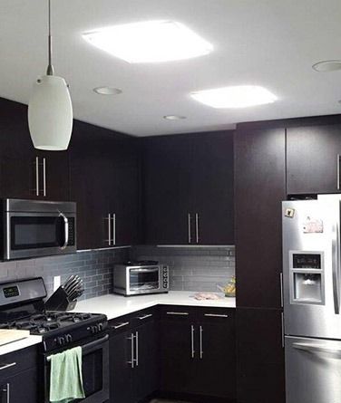 A Kitchen With Stainless Steel Appliances And Black Cabinets — The Woolmen In Alstonville, NSW