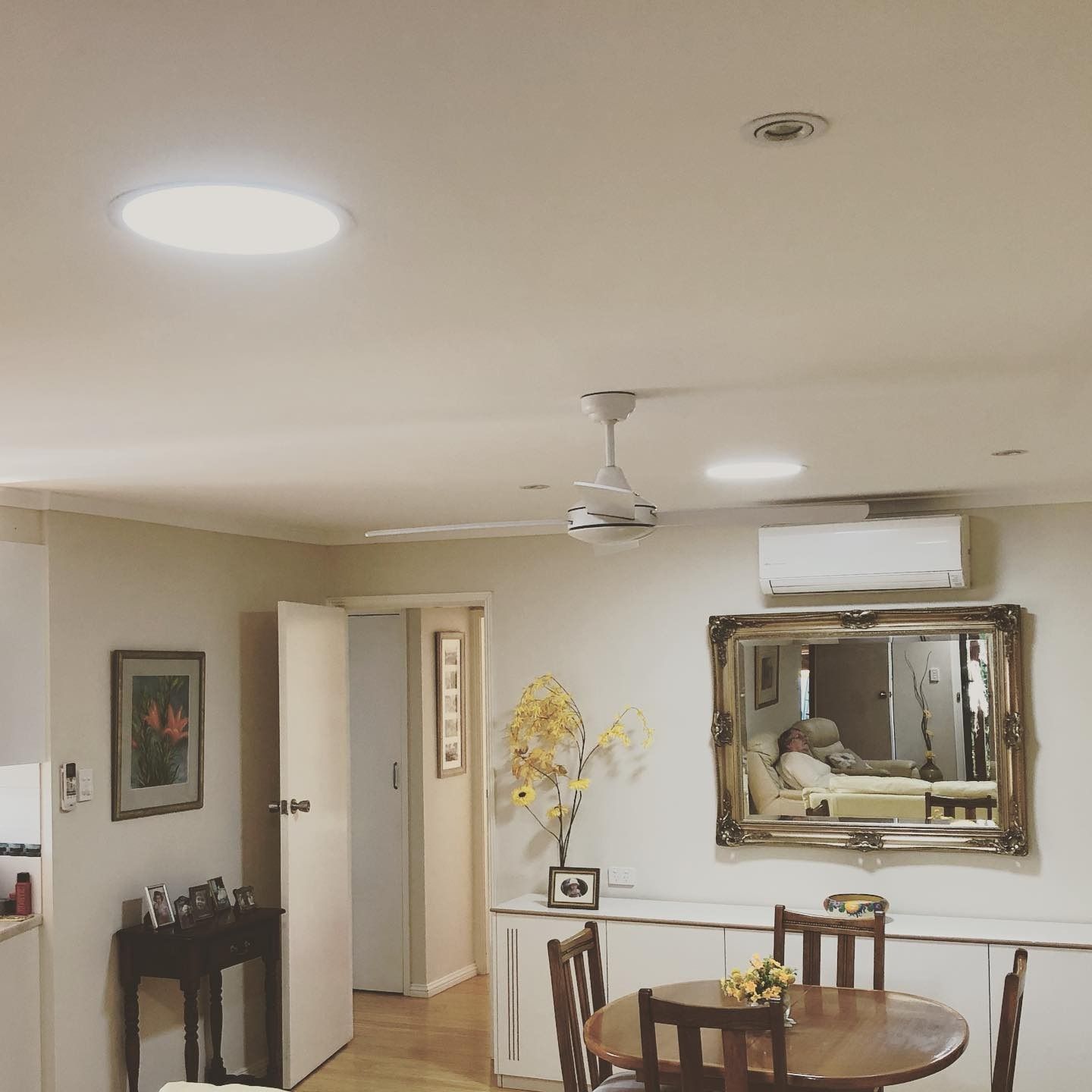 A Living Room With A Table And Chairs And A Mirror — The Woolmen In Ballina, NSW