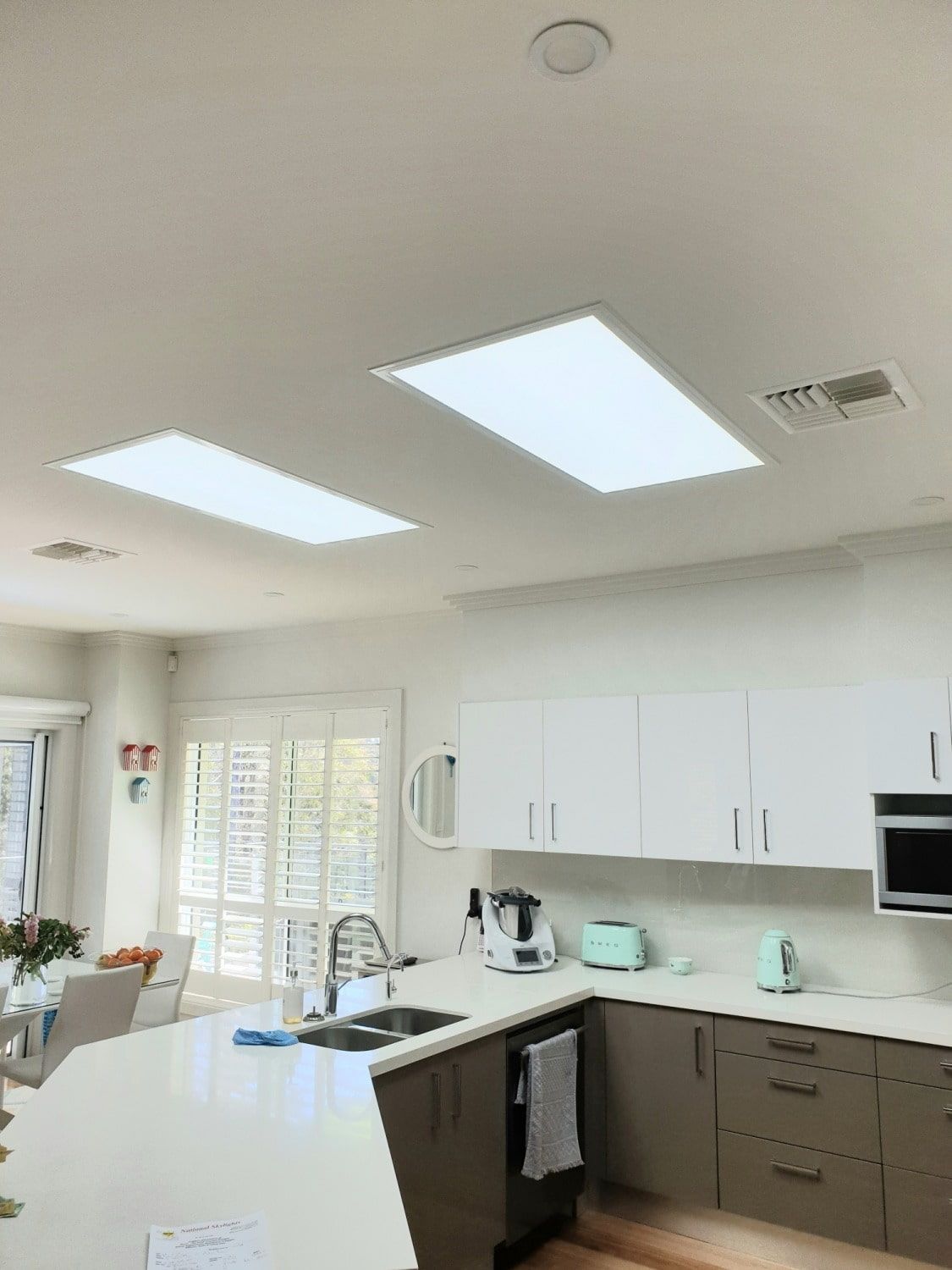 A Kitchen With White Cabinets, A Sink, And A Microwave — The Woolmen In Yamba, NSW