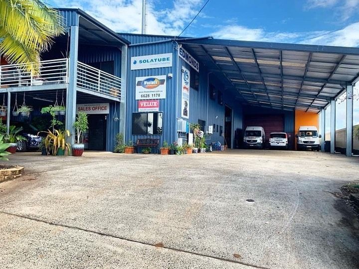 A Large Building With A Lot Of Cars Parked In Front Of It — The Woolmen In Alstonville, NSW