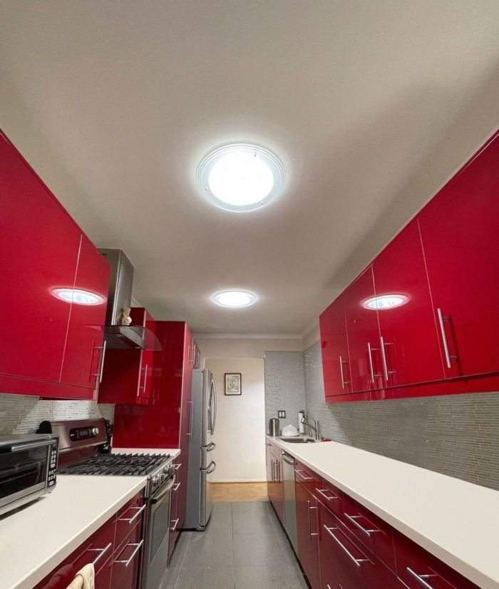 A Kitchen With Red Cabinets And White Counter Tops — The Woolmen In Alstonville, NSW