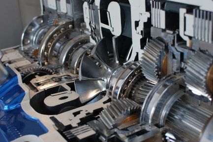 Close-up of shiny metal gears and mechanical components inside a machine