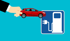 Hand plugging a red electric car into a charging station icon on blue background
