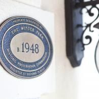 Oval blue plaque on a white wall reading “The Winter Park,” with the year 1948.