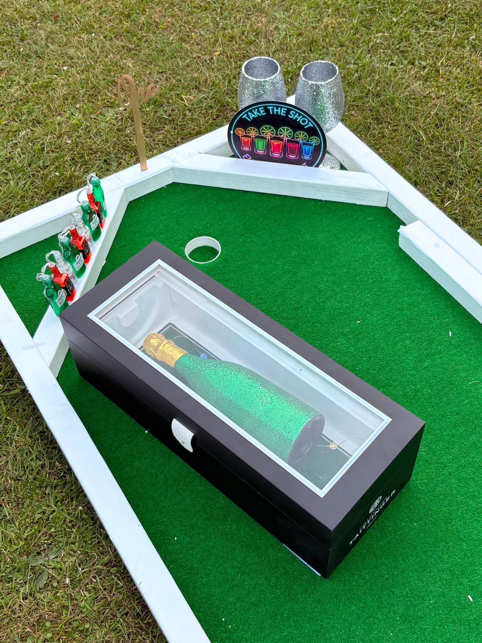 Close-up of a numbered mini golf flag pin on turf