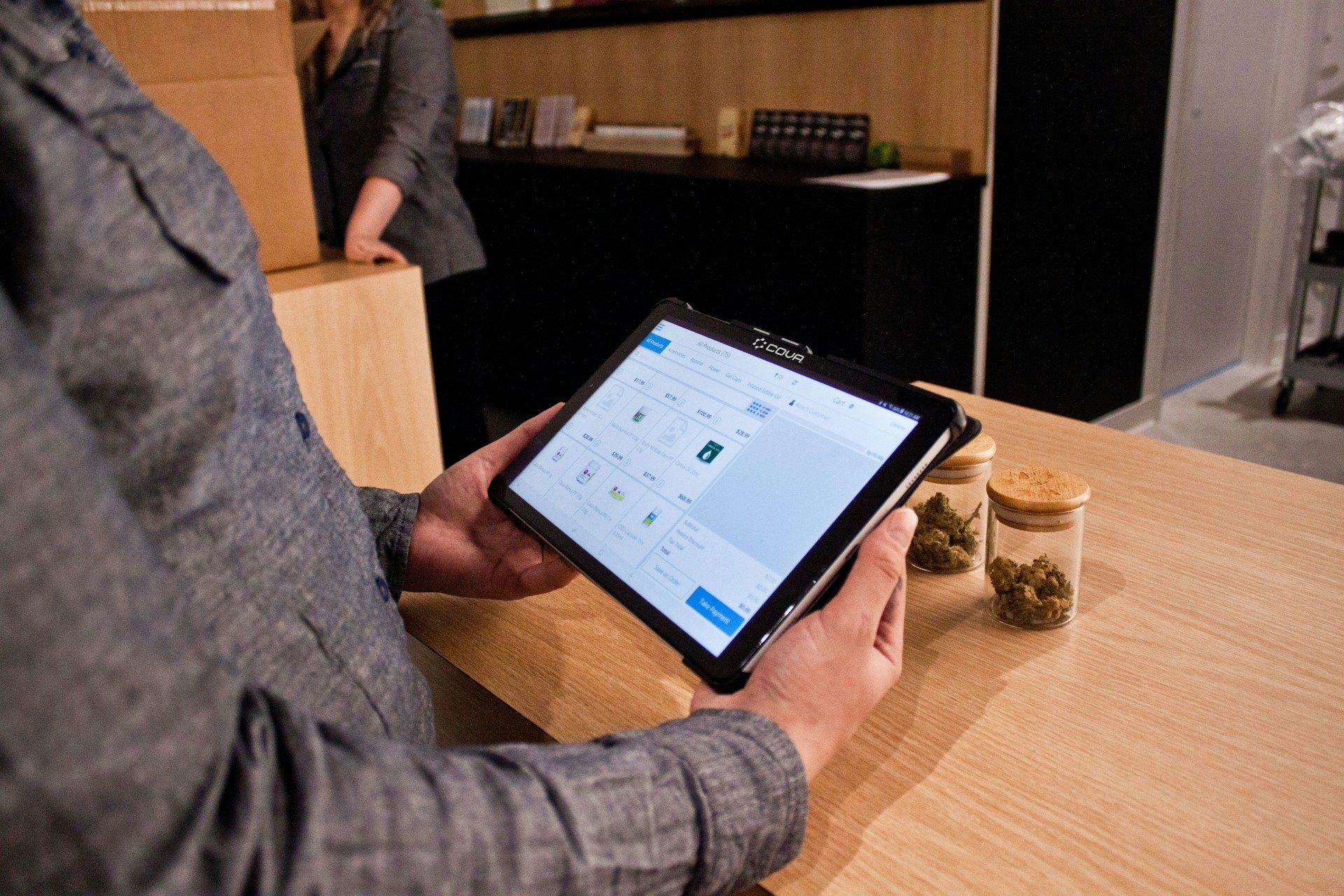 A man is using a tablet computer while sitting at a table.
