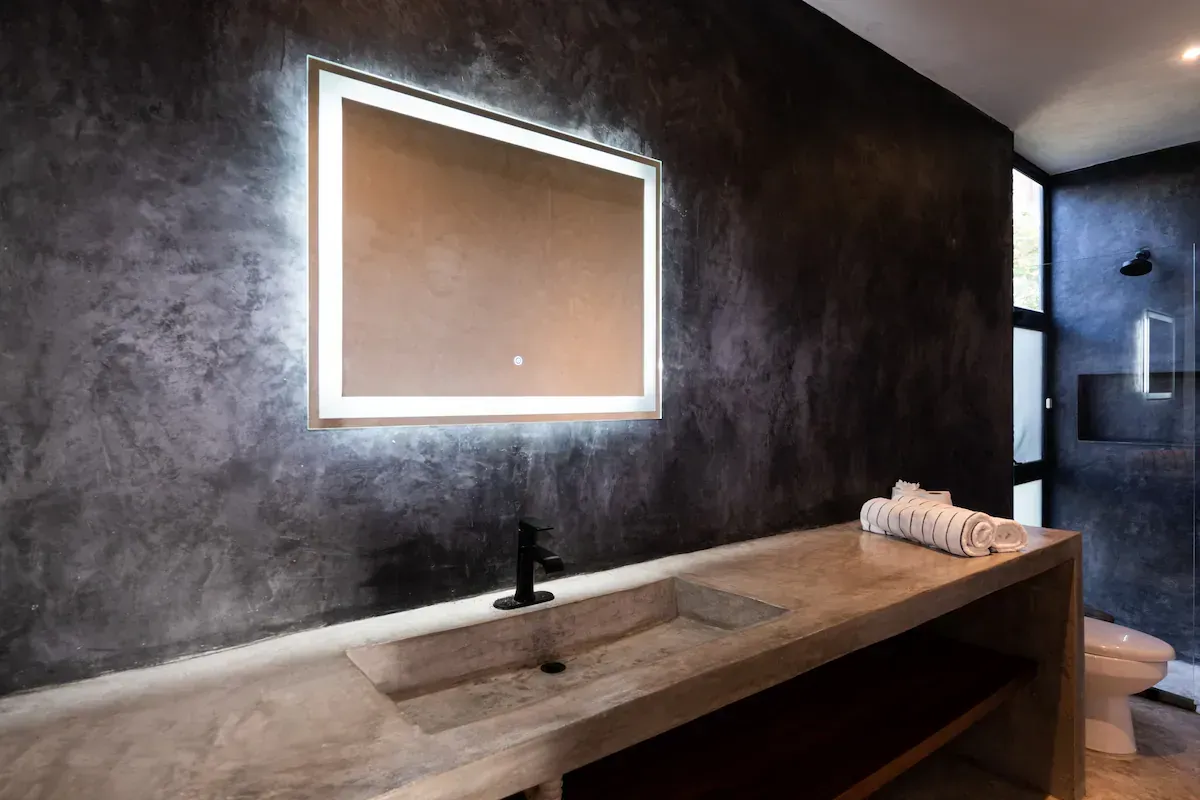 A bathroom with a sink and a mirror on the wall.