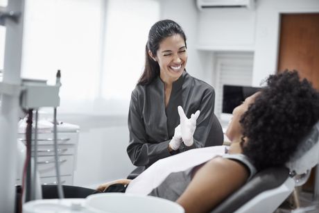 woman being counseled by dentist at Sewell Dental Designs