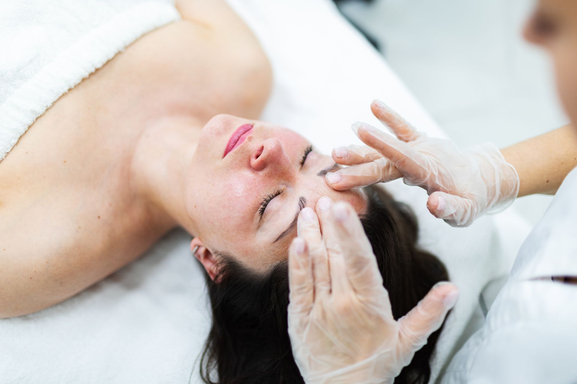 A woman is getting a facial massage. A woman is getting a facial massage.