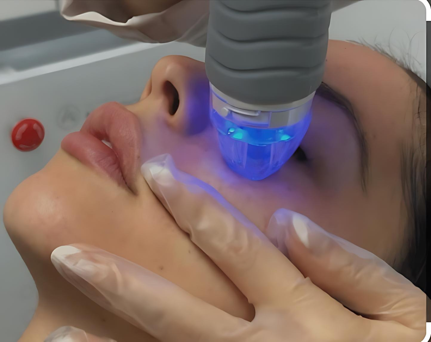 A woman is getting a facial treatment at a beauty salon with a towel on the head