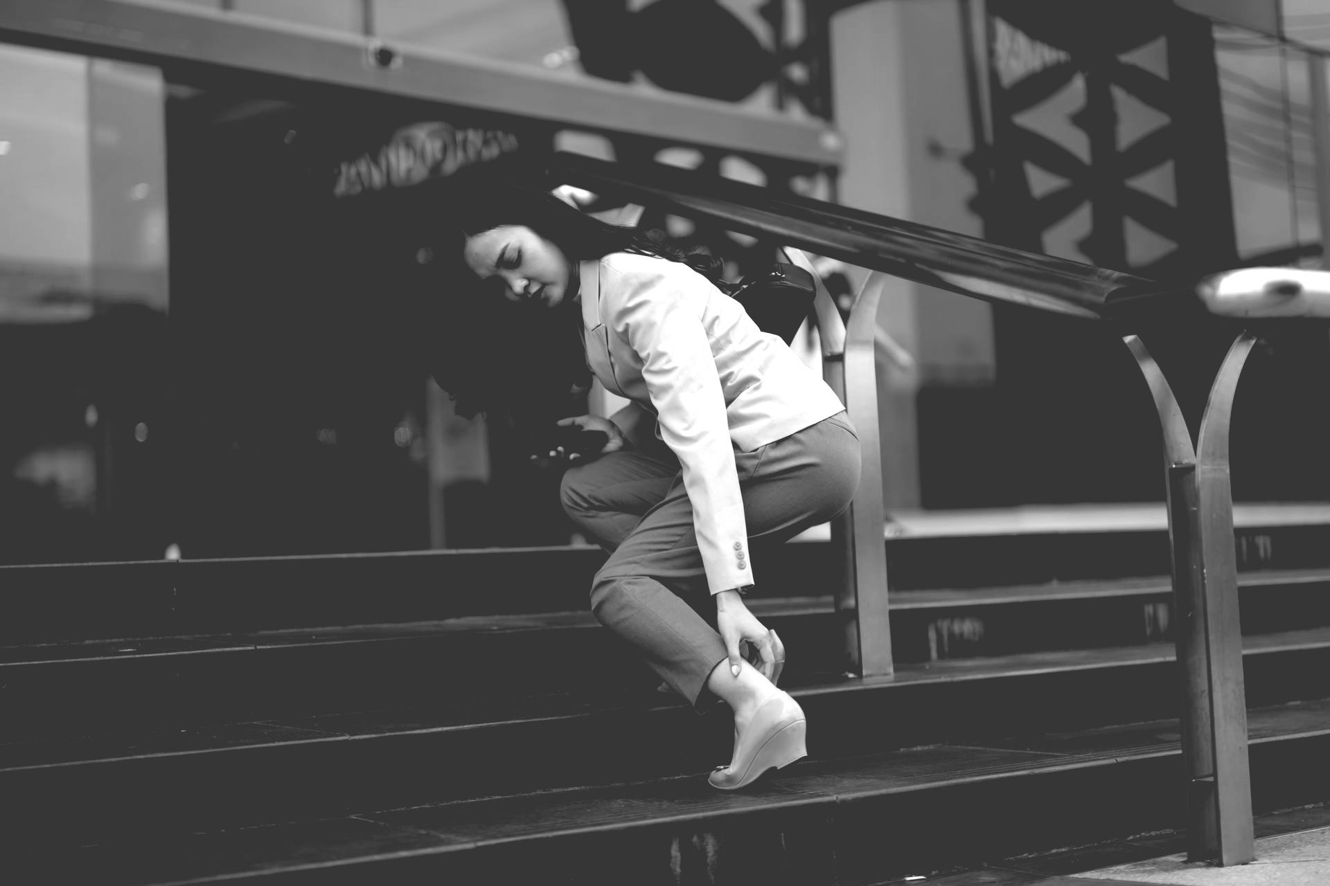 Person in white shirt climbing stairs outside a building.