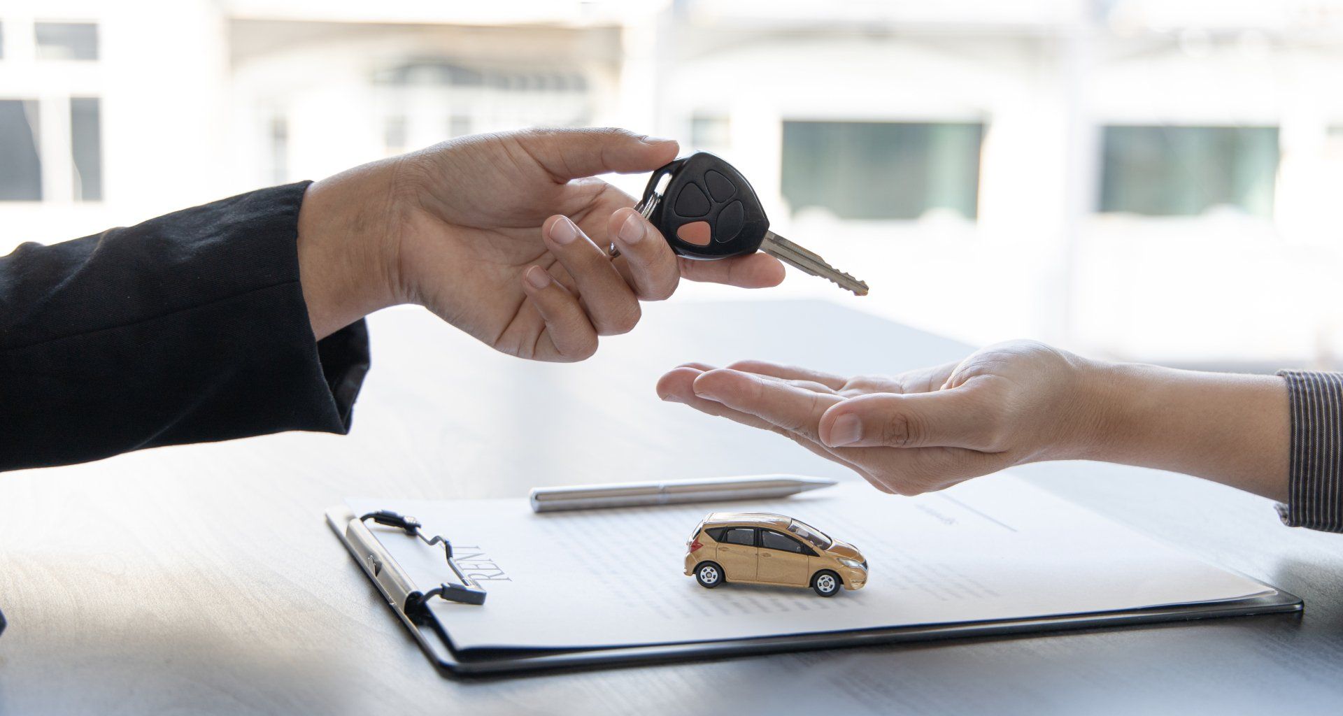 Car salesman gave the keys to the customers who signed the purchase contract legally.