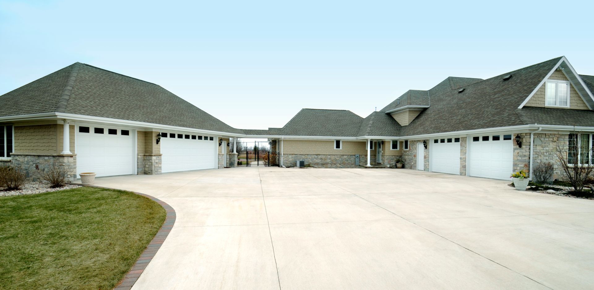A large house with a lot of garage doors and a concrete driveway - Gibsonia, PA - Langell Concrete Construction