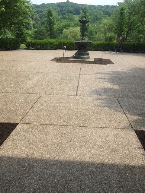 A patio with a fountain in the middle of it - Gibsonia, PA - Langell Concrete Construction