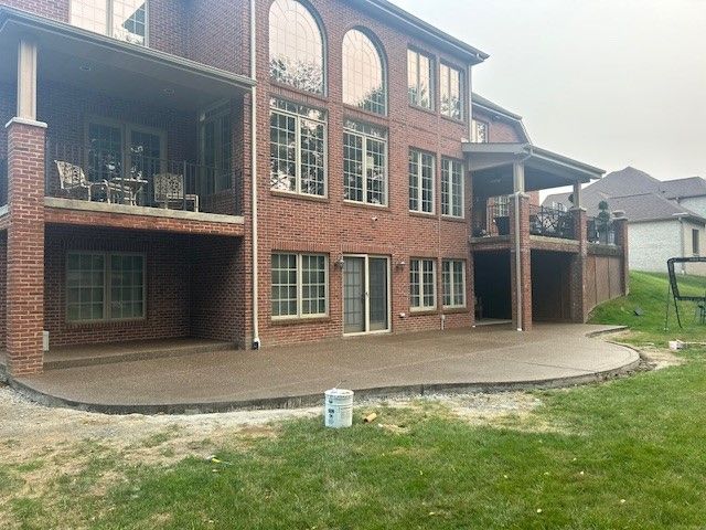 A large brick house with a large patio in front of it. - Gibsonia, PA - Langell Concrete Construction