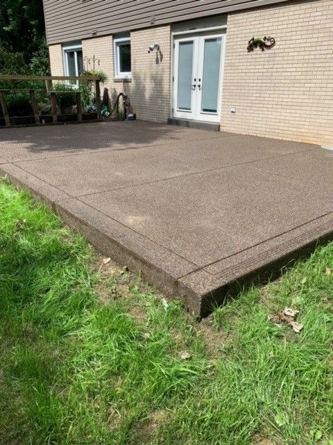 A brick house with a patio in front of it - Gibsonia, PA - Langell Concrete Construction