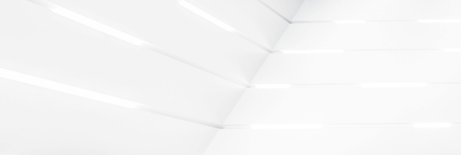 White architectural interior with linear patterns and lighting.