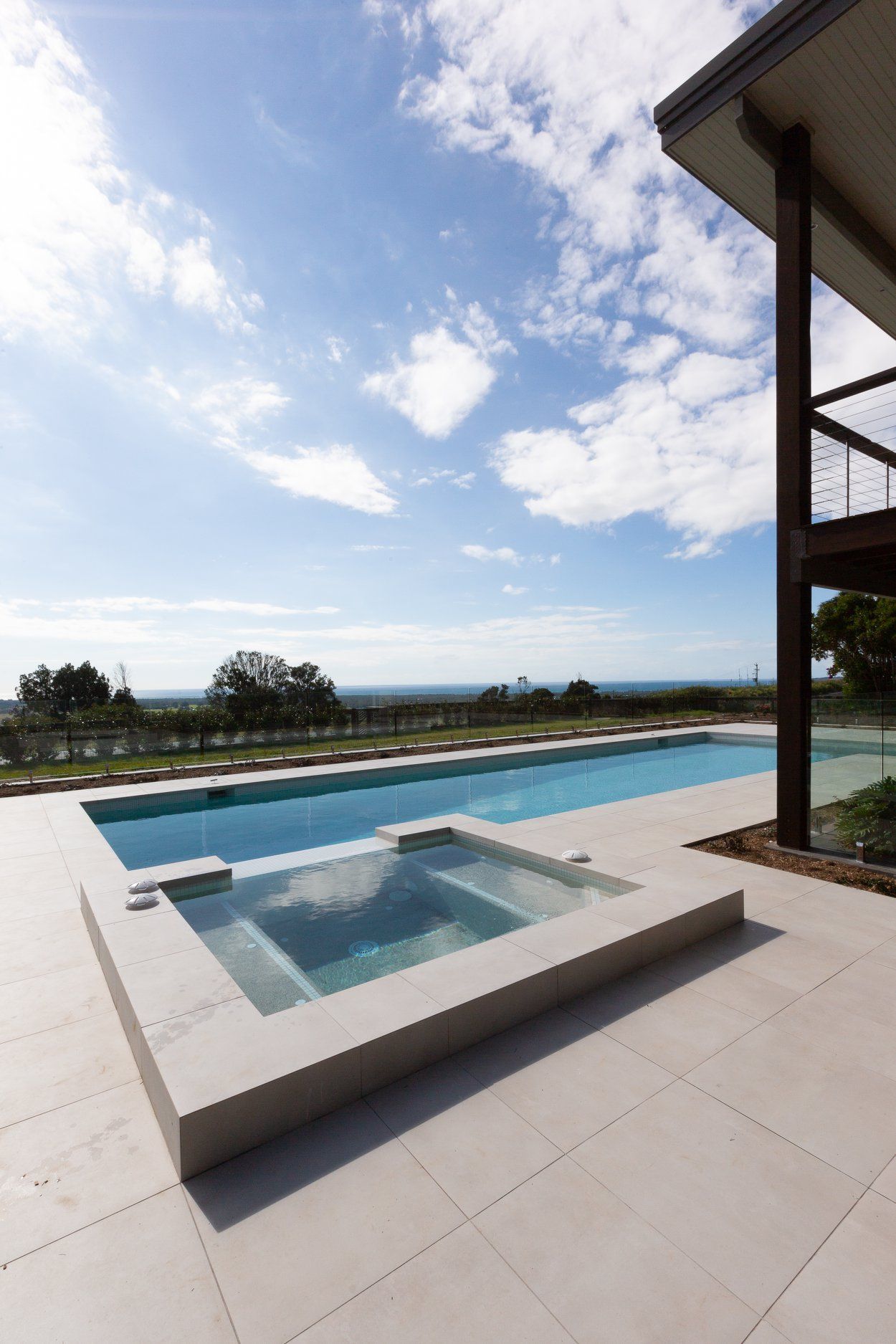 A Large Swimming pool with a hot tub next to it — Profile Pools & Landscaping In Byron Bay, NSW