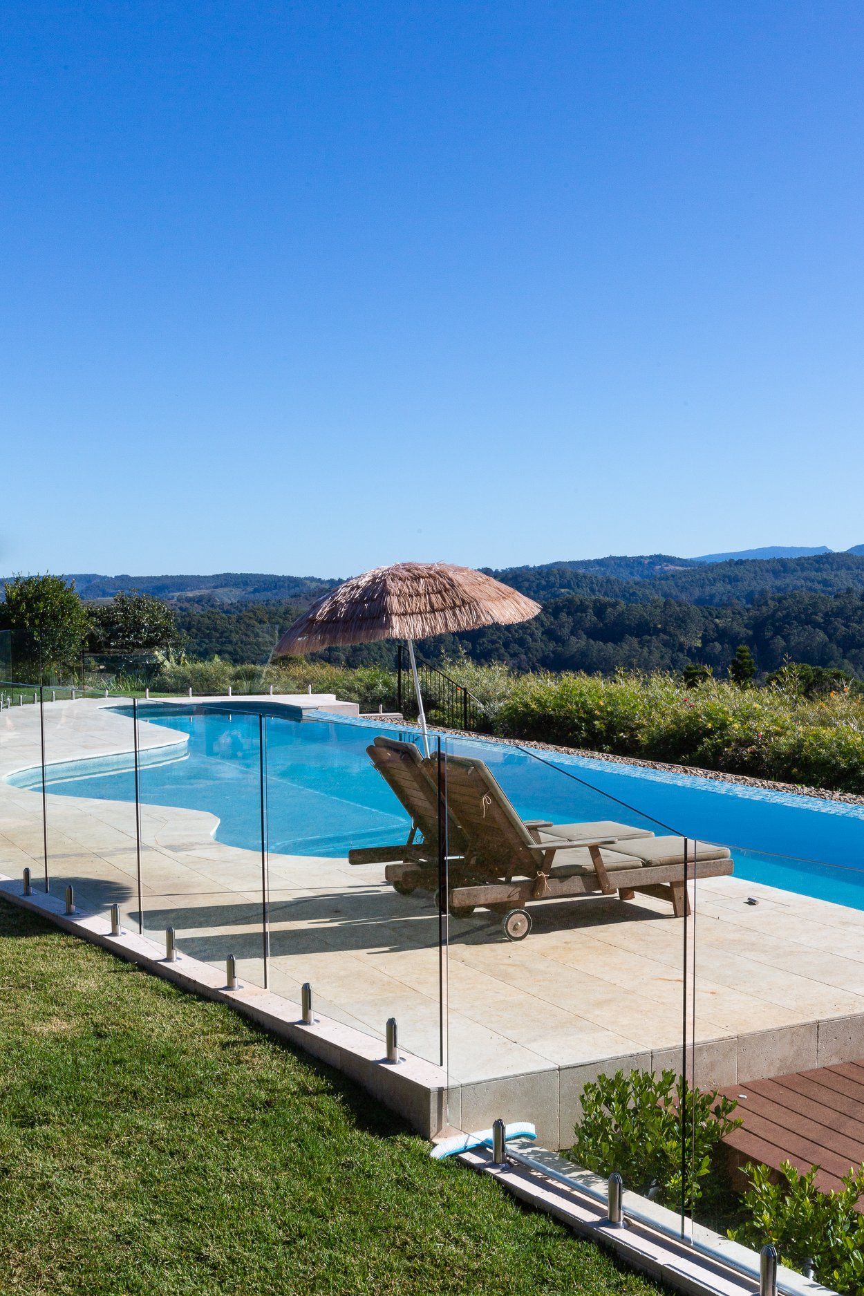 There is a Swimming pool with a view of the Mountains in the Background — Profile Pools & Landscaping In Byron Bay, NSW