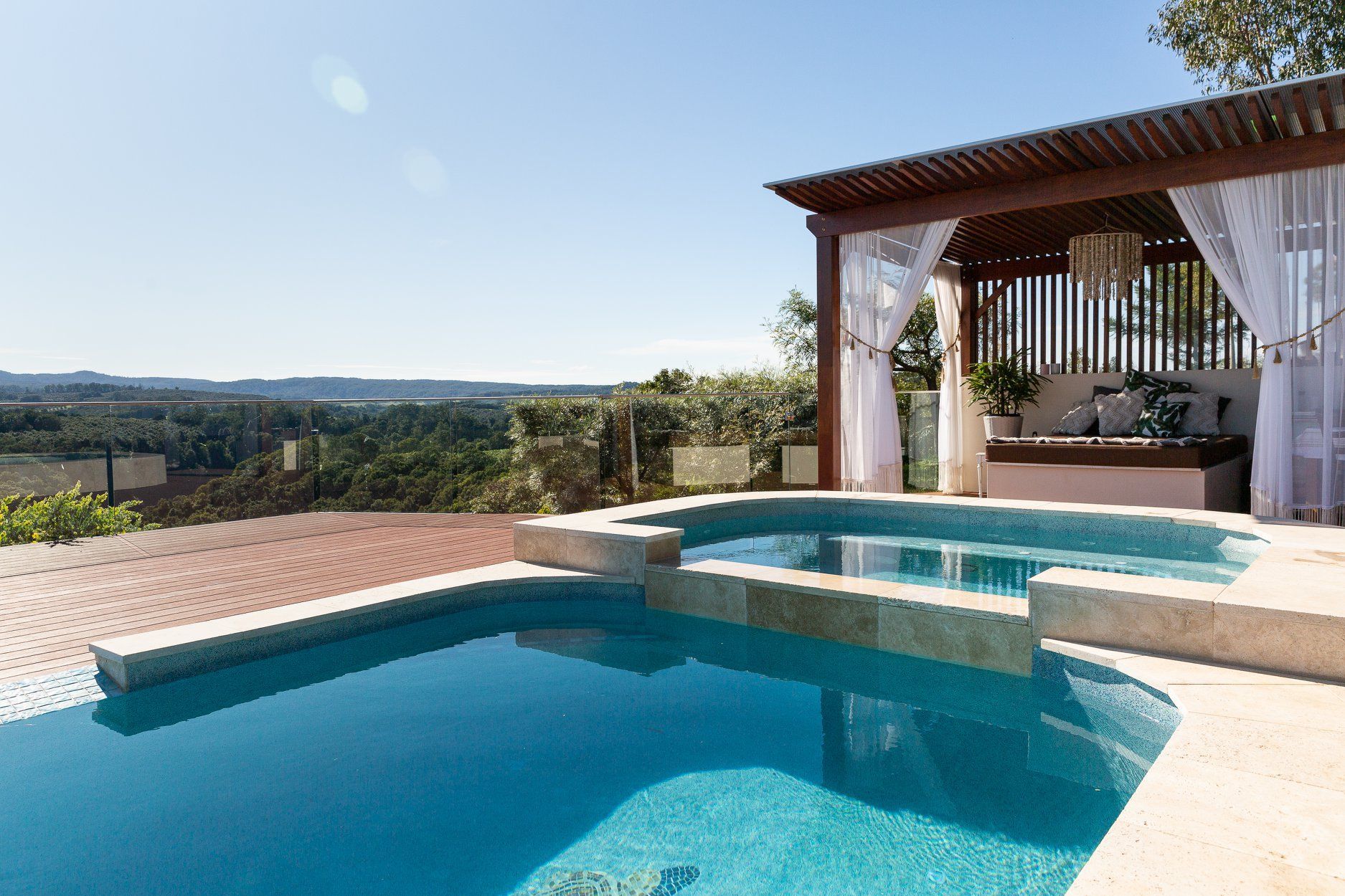 A large Swimming pool with a Gazebo in the Background — Profile Pools & Landscaping In Byron Bay, NSW