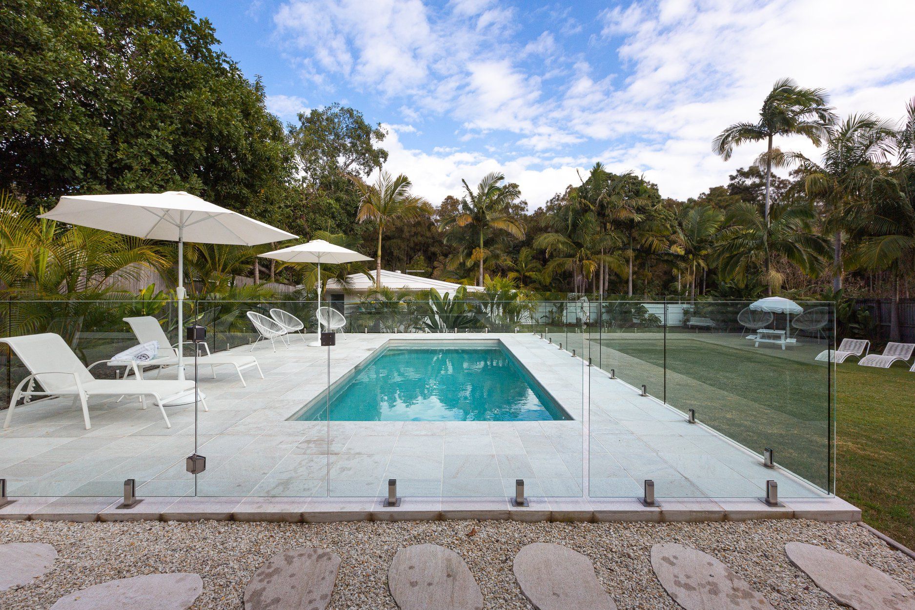 Swimming  Pool With Two Sun Loungers In The Background — Profile Pools & Landscaping In Evans Head, NSW
