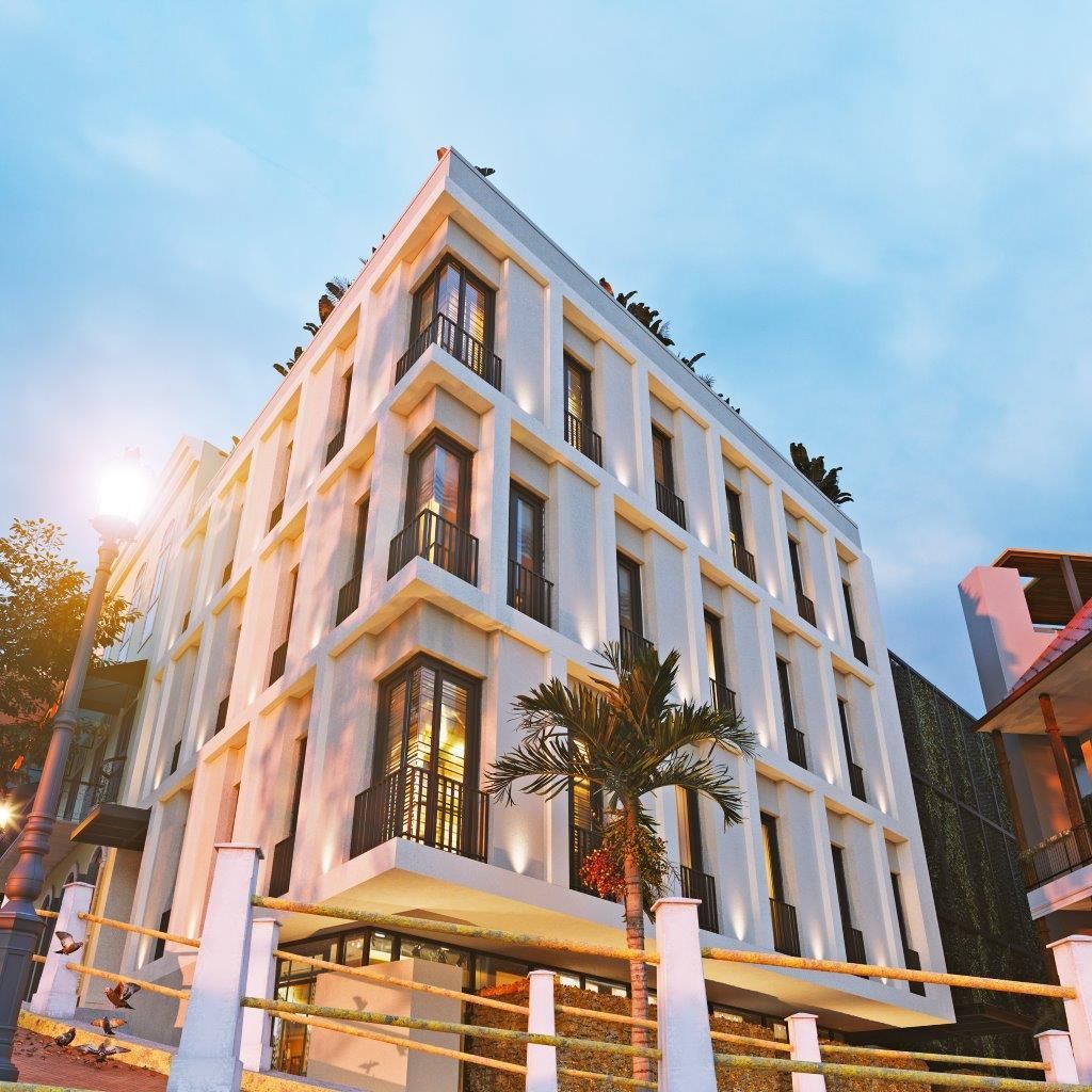 Un gran edificio blanco con muchas ventanas y balcones.