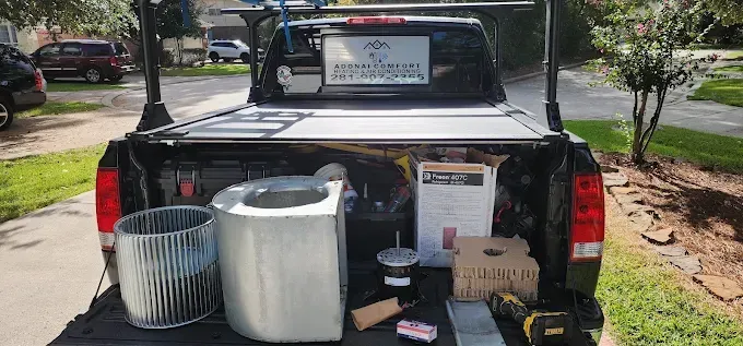 Pickup truck tailgate display with buckets, boxes, and supplies at an outdoor event.