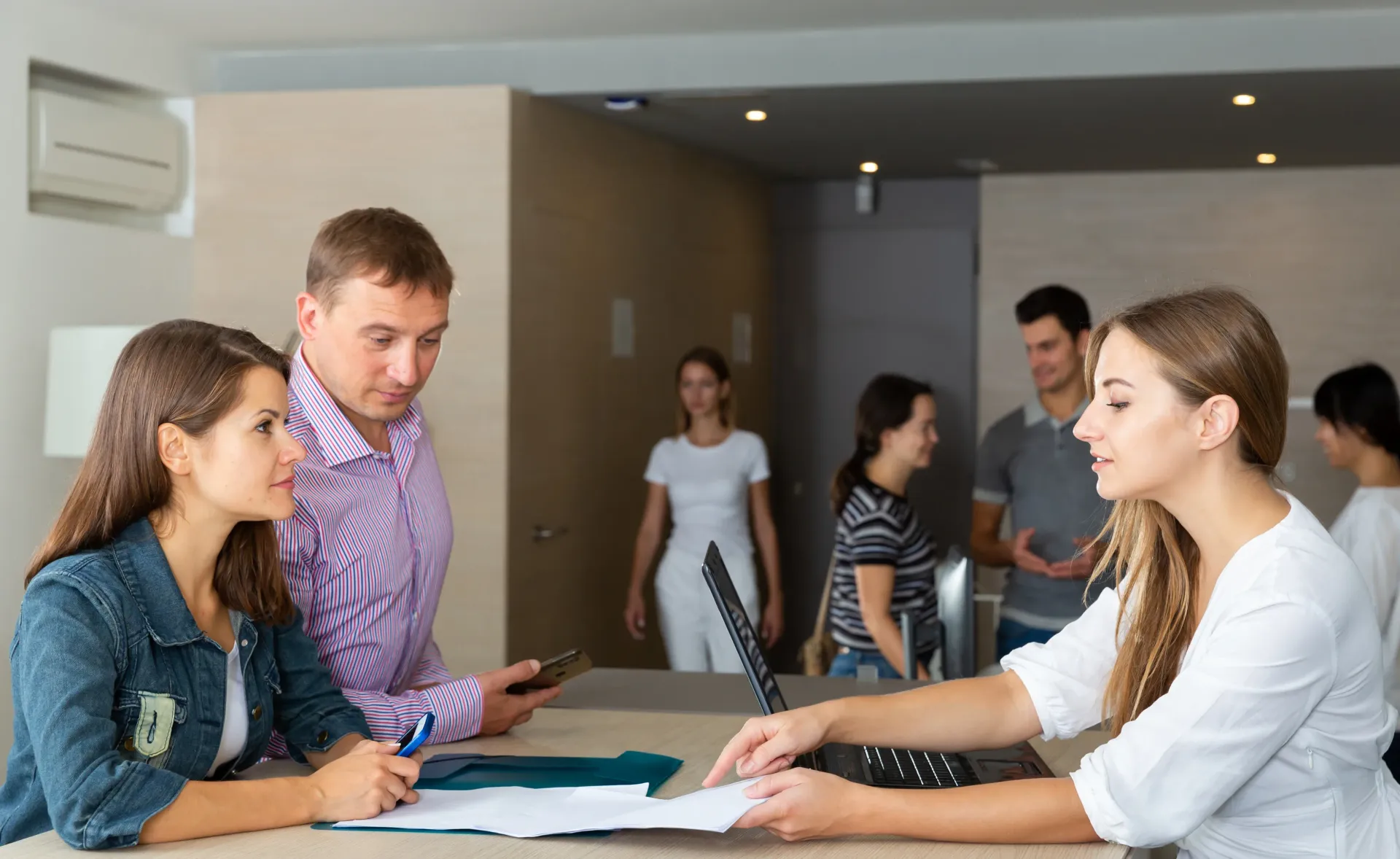 A group of people are sitting at a table in a room.