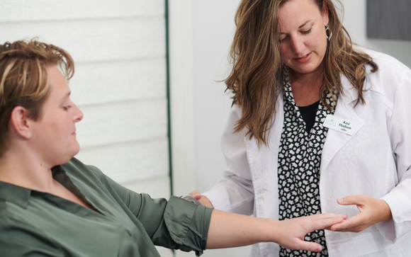 Doctor examining a patient’s wrist in a clinic