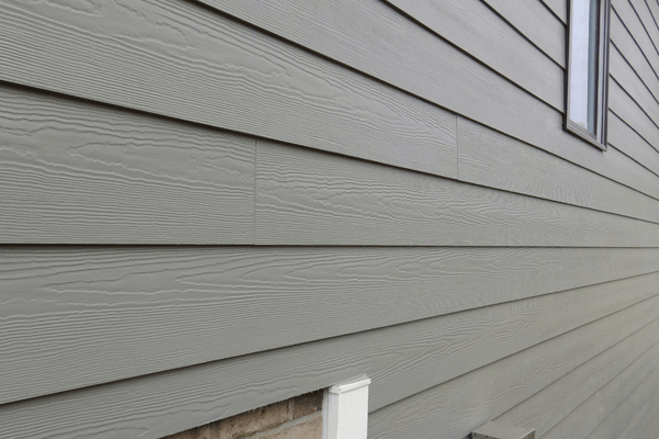 Backyard view of home with new blue siding installation and patio area, completed by DMF Construction in Scotch Plains, NJ.