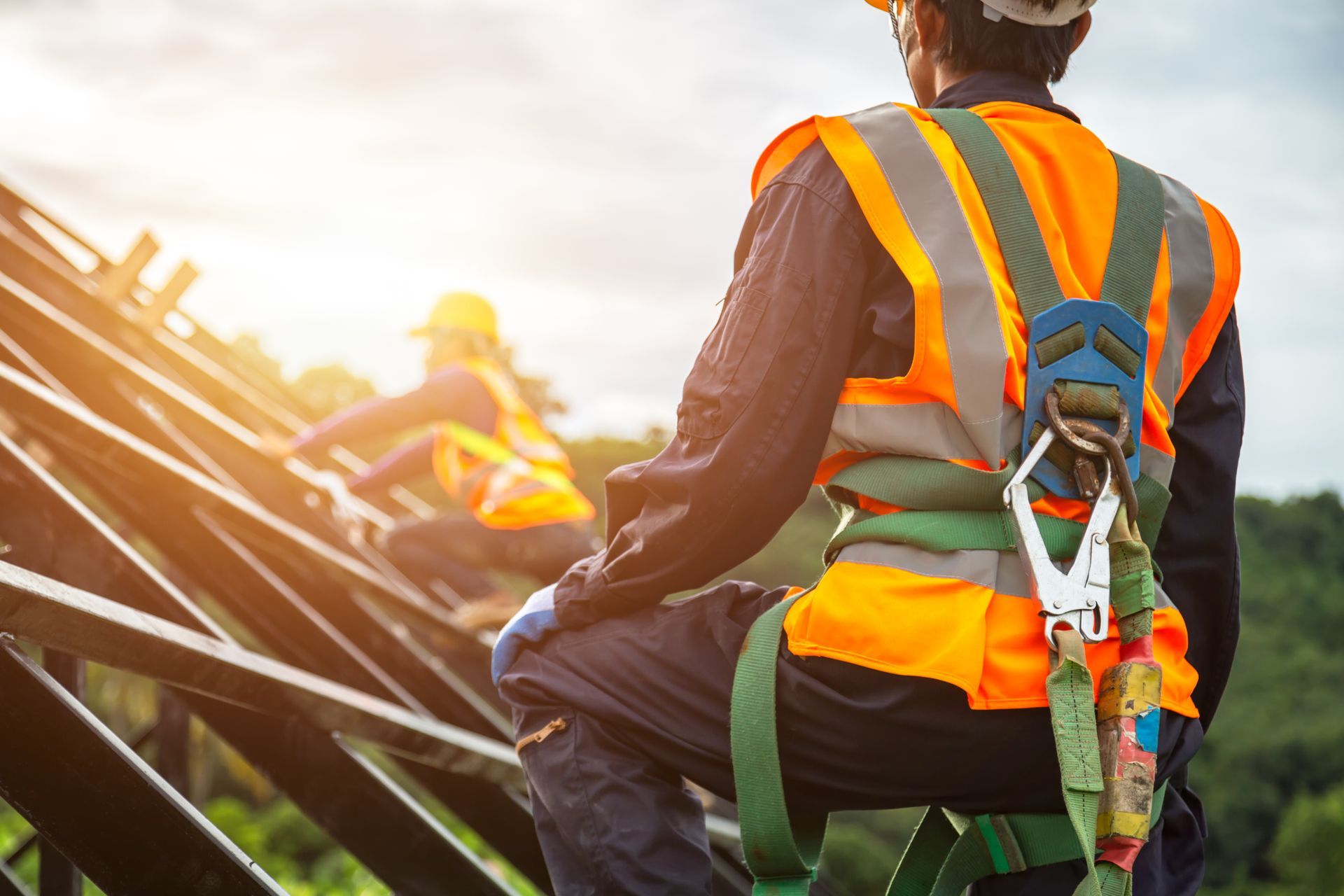 Professional installer working on a modern metal roof under a vibrant sunset in Chatham, NJ, showcasing durable and energy-efficient roofing solutions.