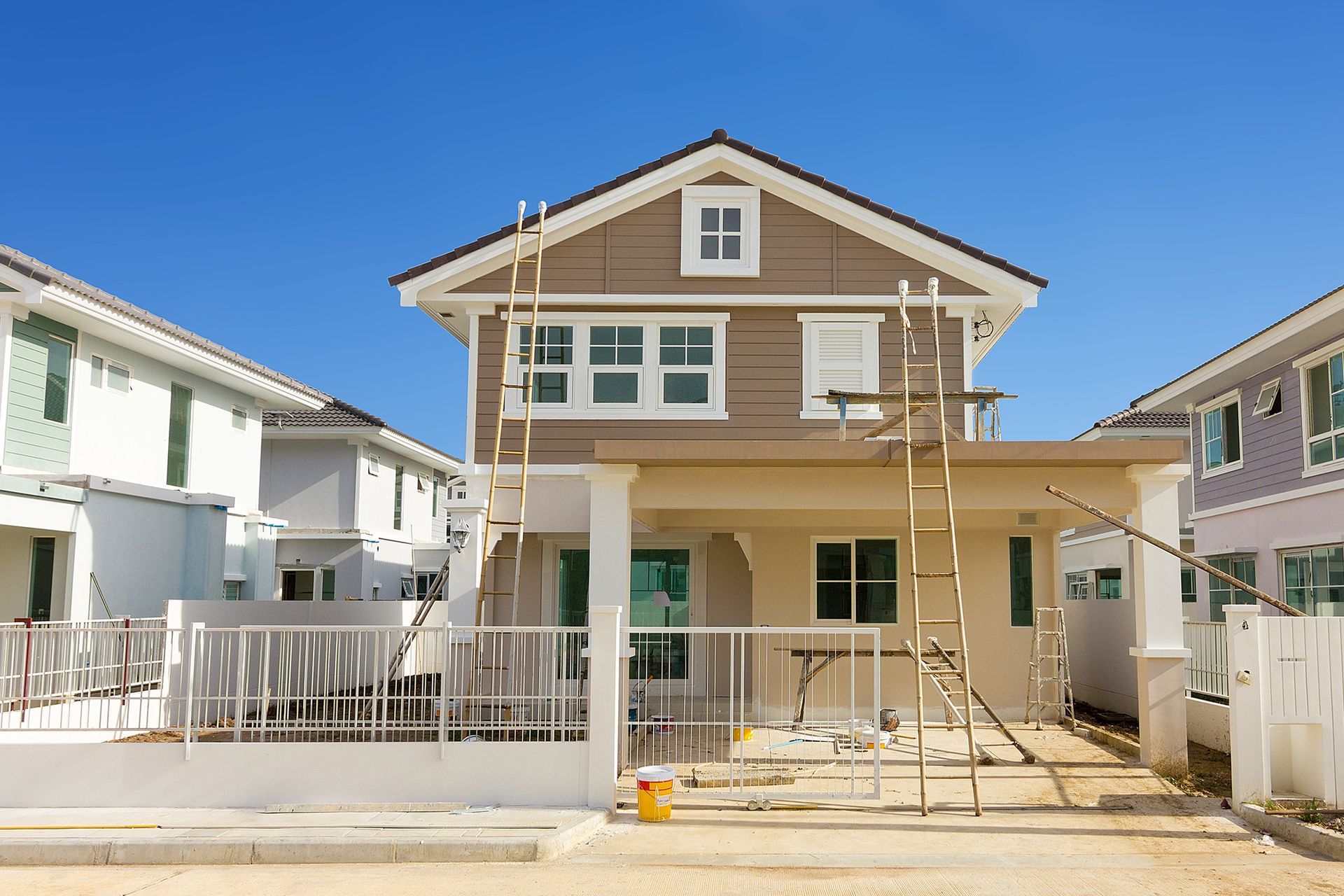 A house is being painted in a residential area.