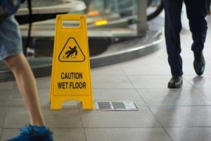 a caution sign with Wet Floor on it.