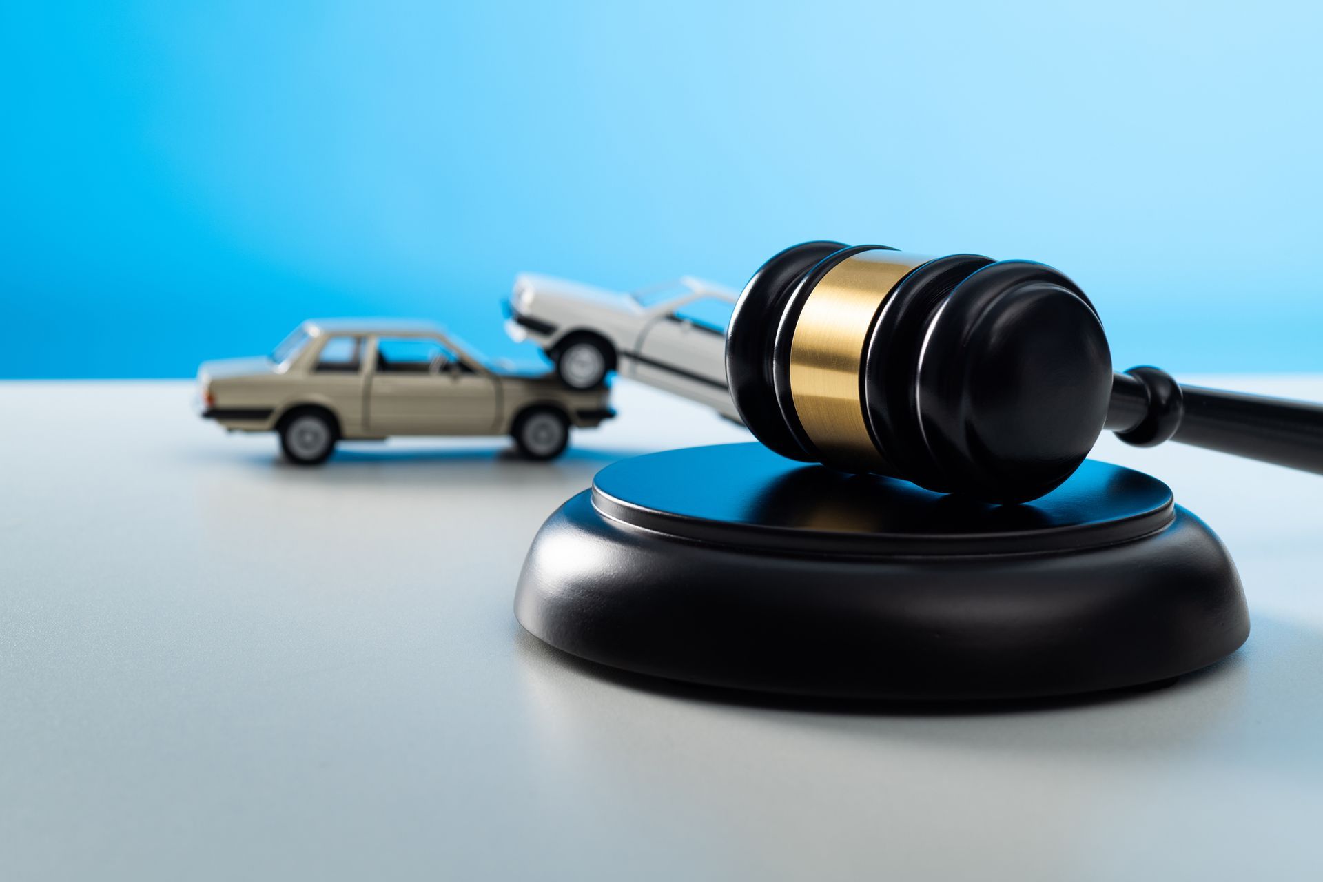 Gavel and model car on the table.