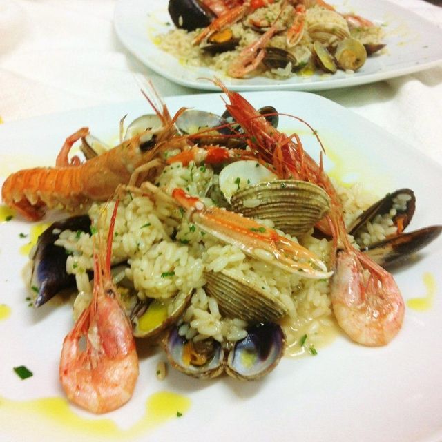 Un tavolo sormontato da piatti di cibo e pane.