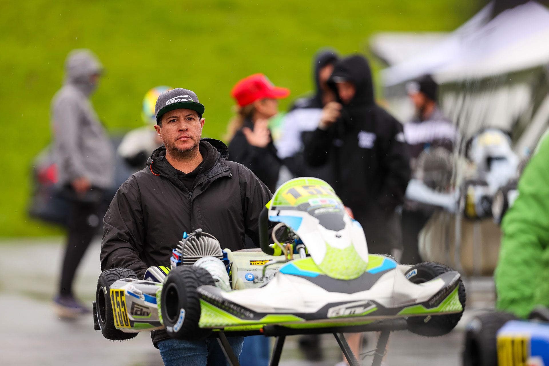 Two people are racing go karts on a track.