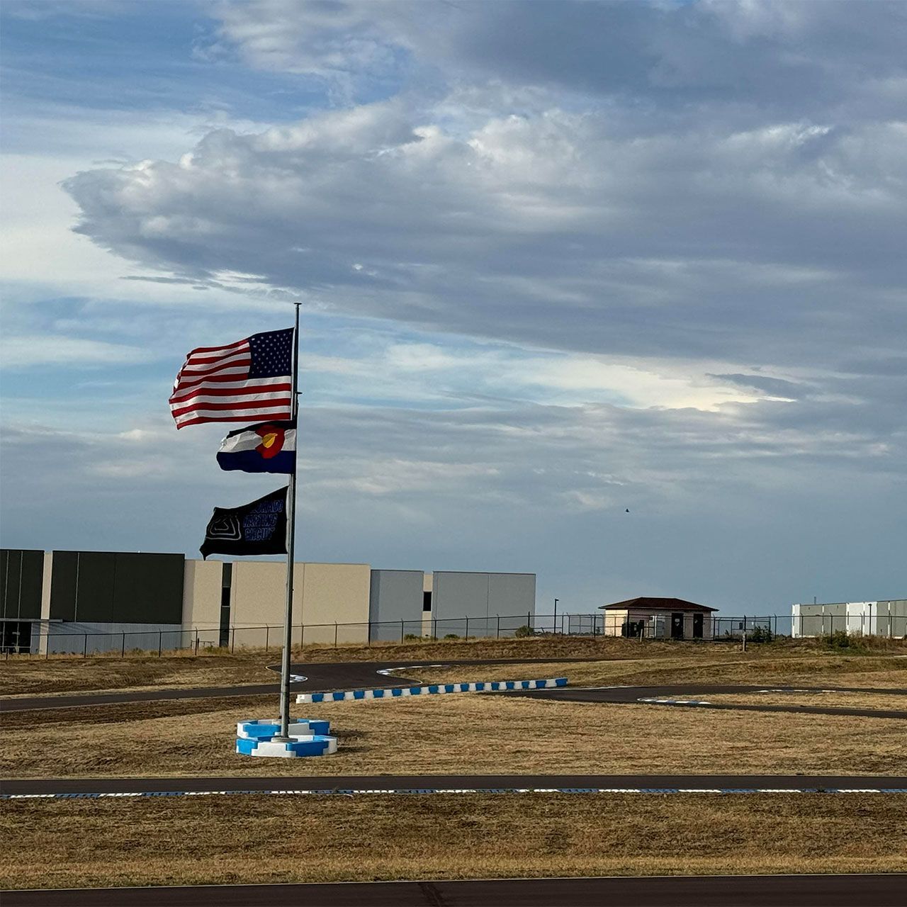 A row of flags on a pole in a field