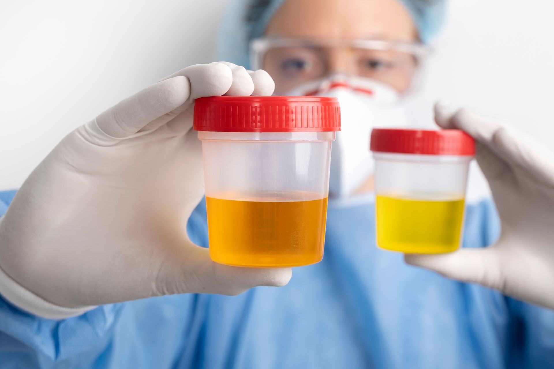 A surgeon is holding two jars of urine in his hands.