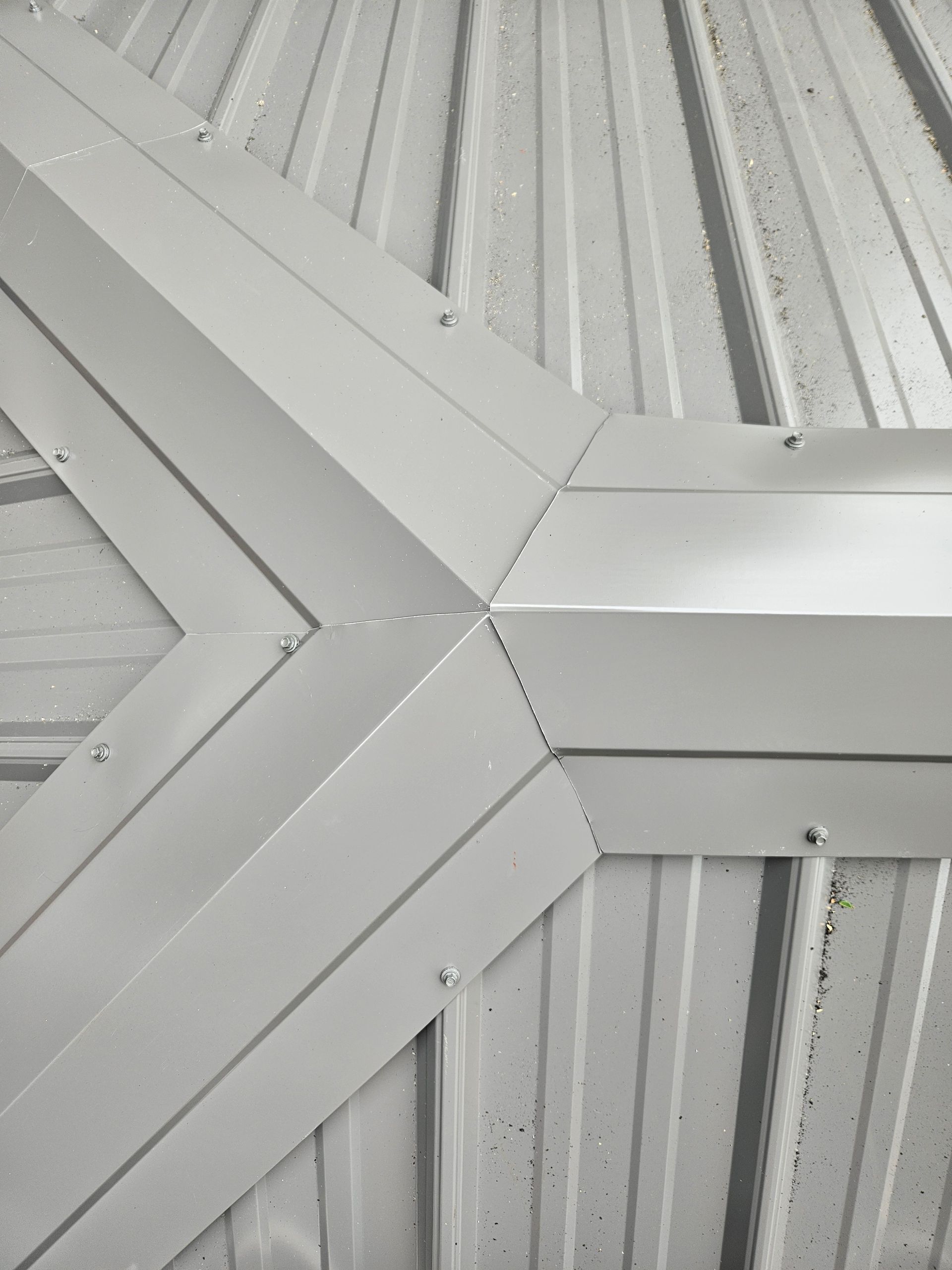 A close up of a metal roof with a corner.