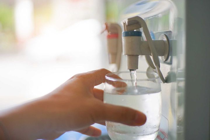 Person getting water from water cooler — Saginaw, MI — Shay Water Co