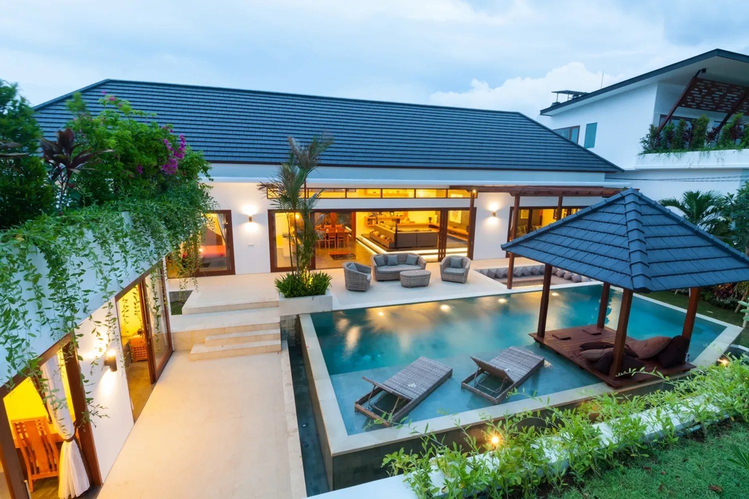 A large house with a large swimming pool in front of it