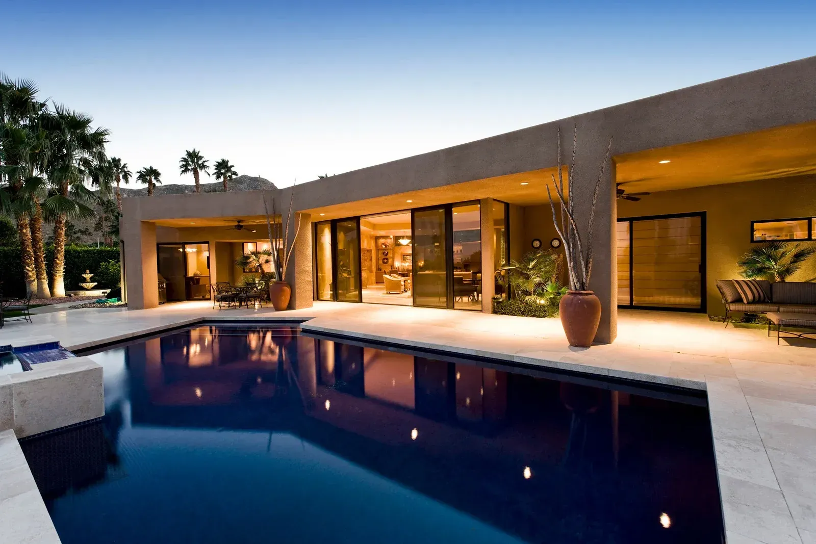 A large house with a large swimming pool in front of it