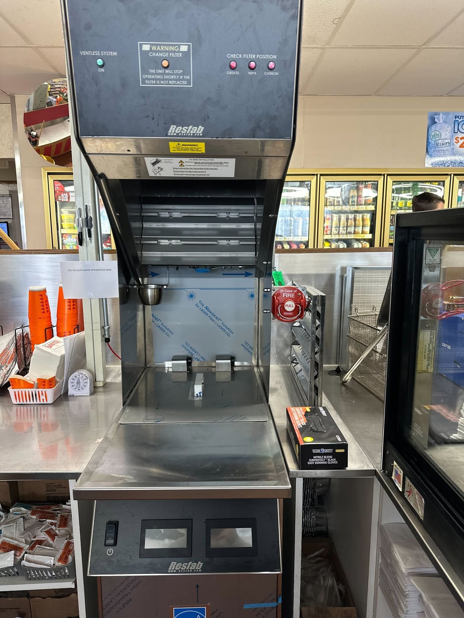 Laboratory fume hood in a store aisle, with equipment and supplies on shelves nearby