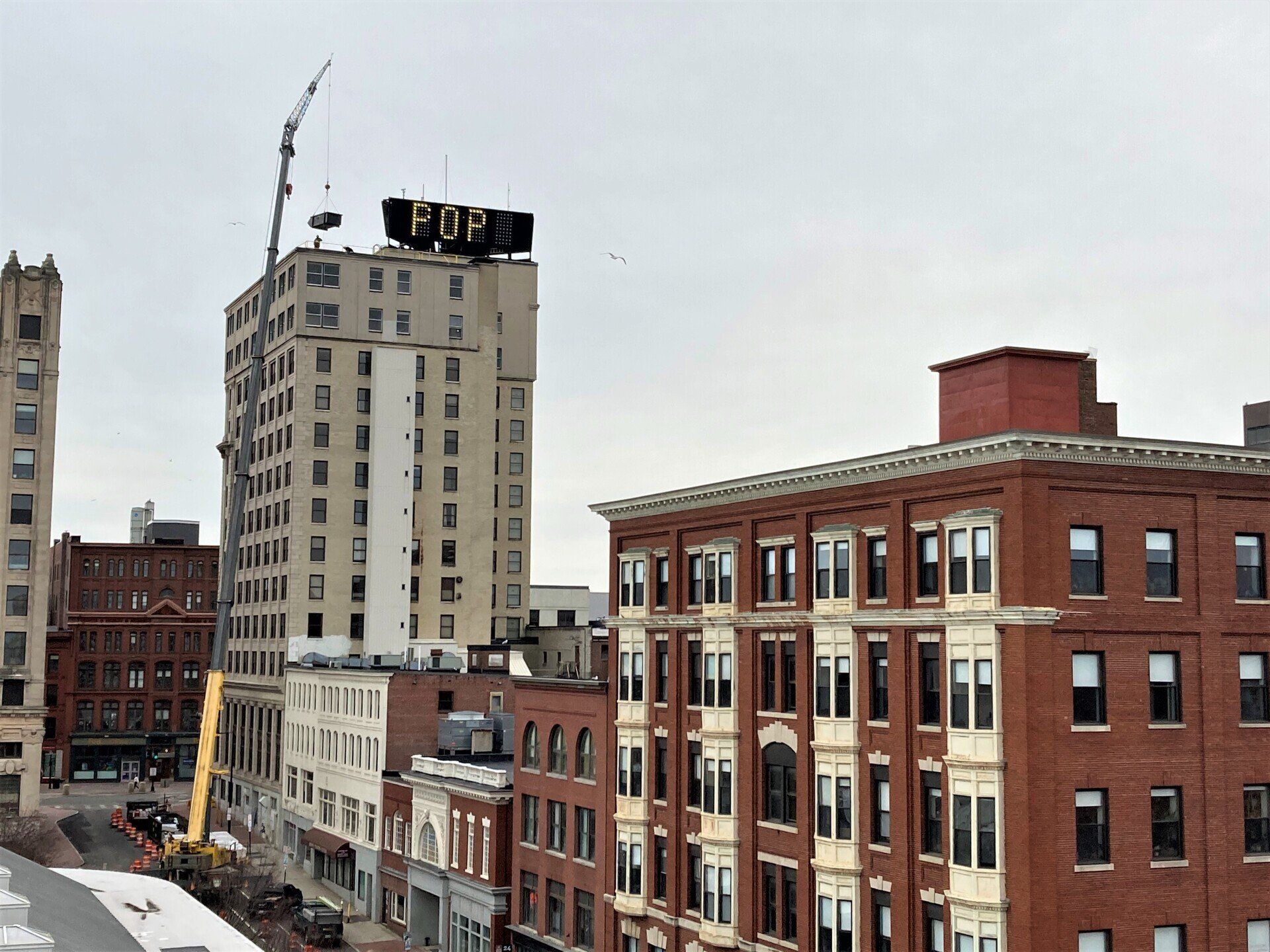 Crane Placing an HVAC Unit on a Building