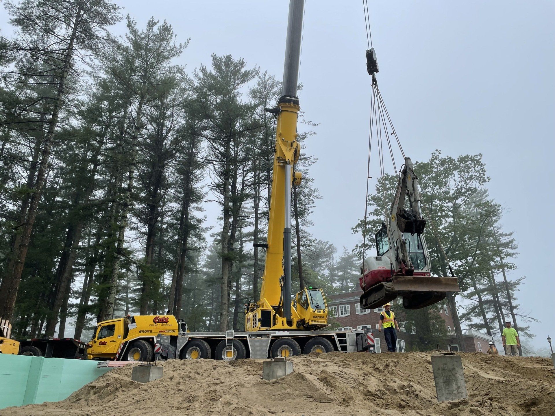 Crane Lifting an Excavator