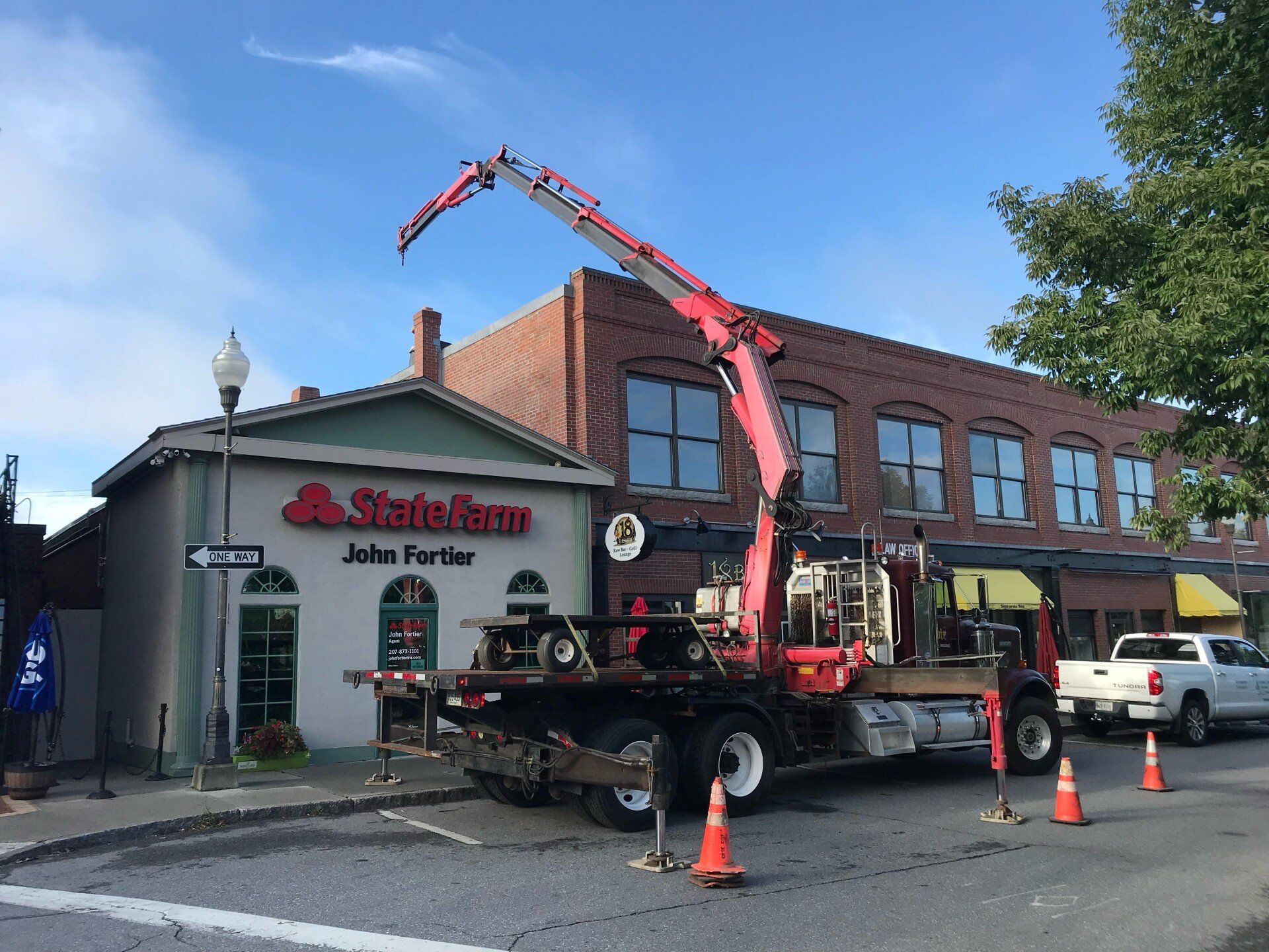Crane and heavy hauling equipment used to hang sign in Maine and New Hampshire
