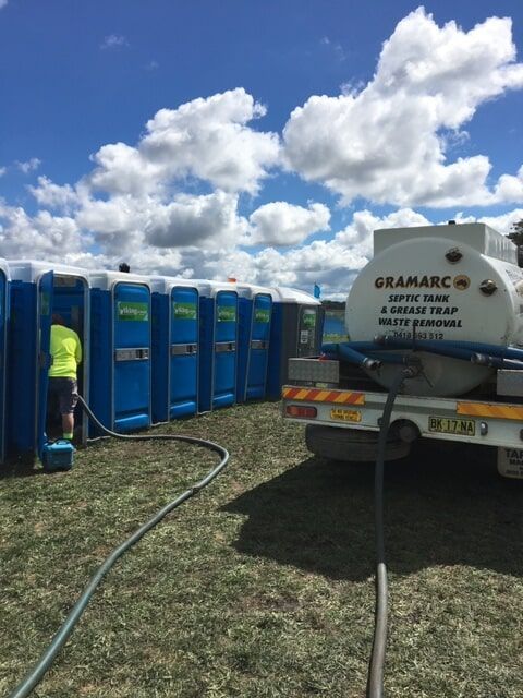 Man Cleaning Portable toilet — Septic Tank Cleaning in Armidale, NSW