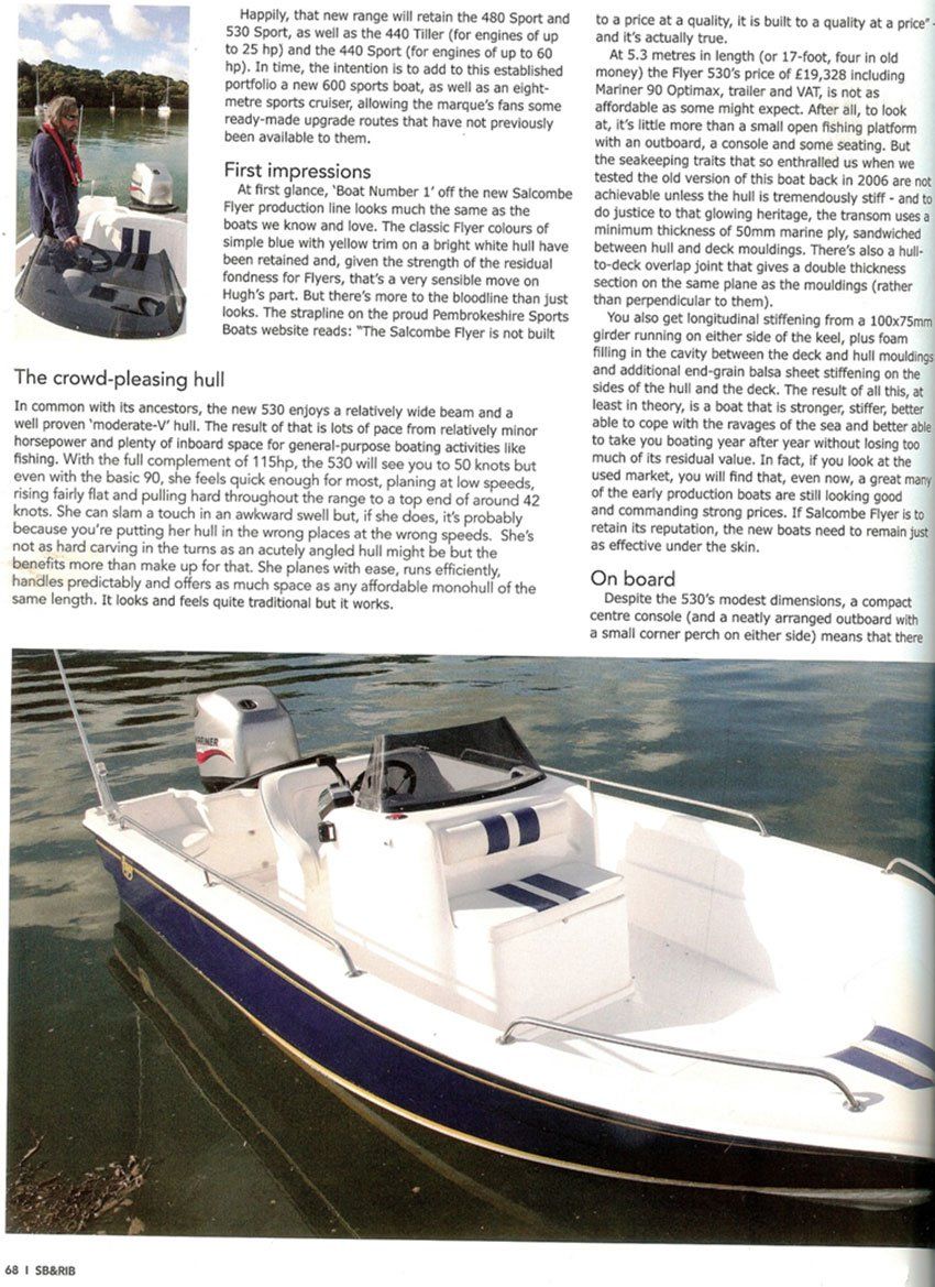 White and blue motorboat on the water; parked near a body of water.
